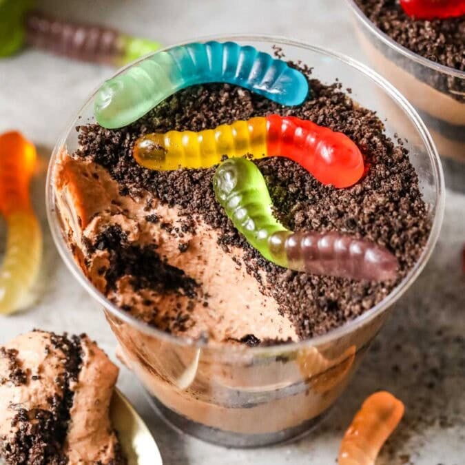 Overhead view of a cup of dirt pudding with one bite missing.