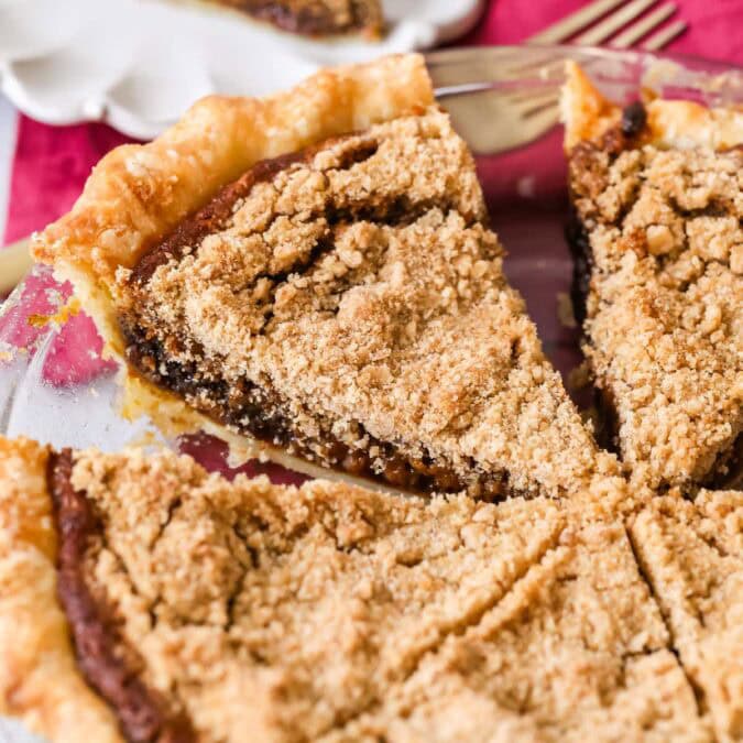 Shoofly pie that's been cut into slices in a pie plate.