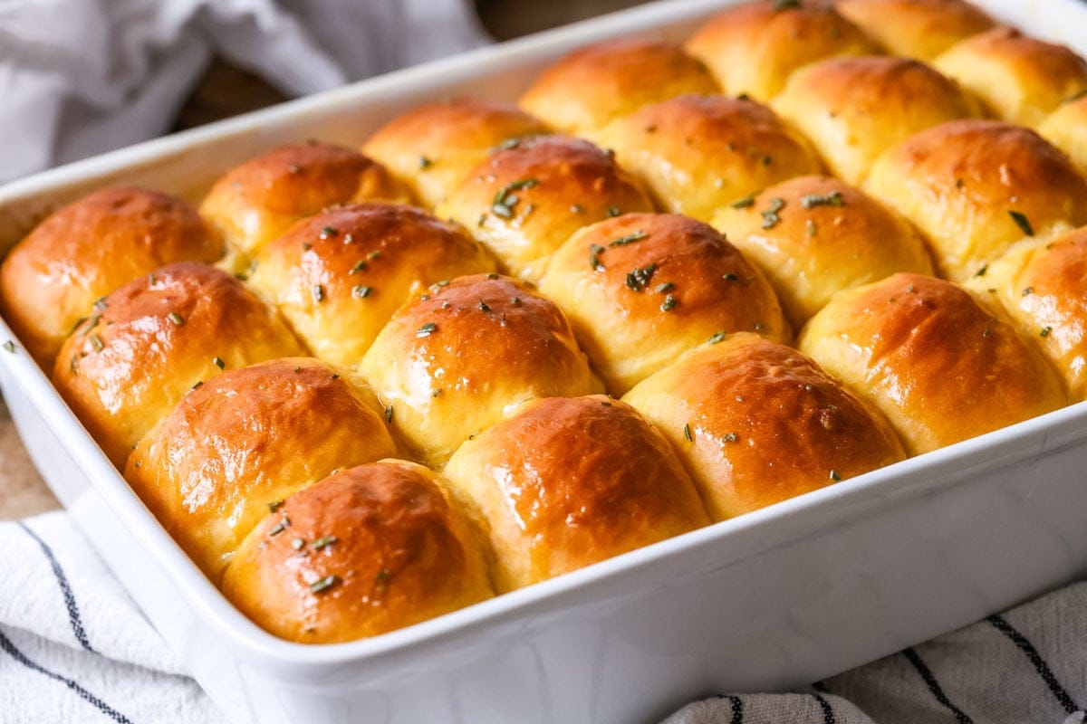 Baking pan of dinner rolls made with sweet potatoes.