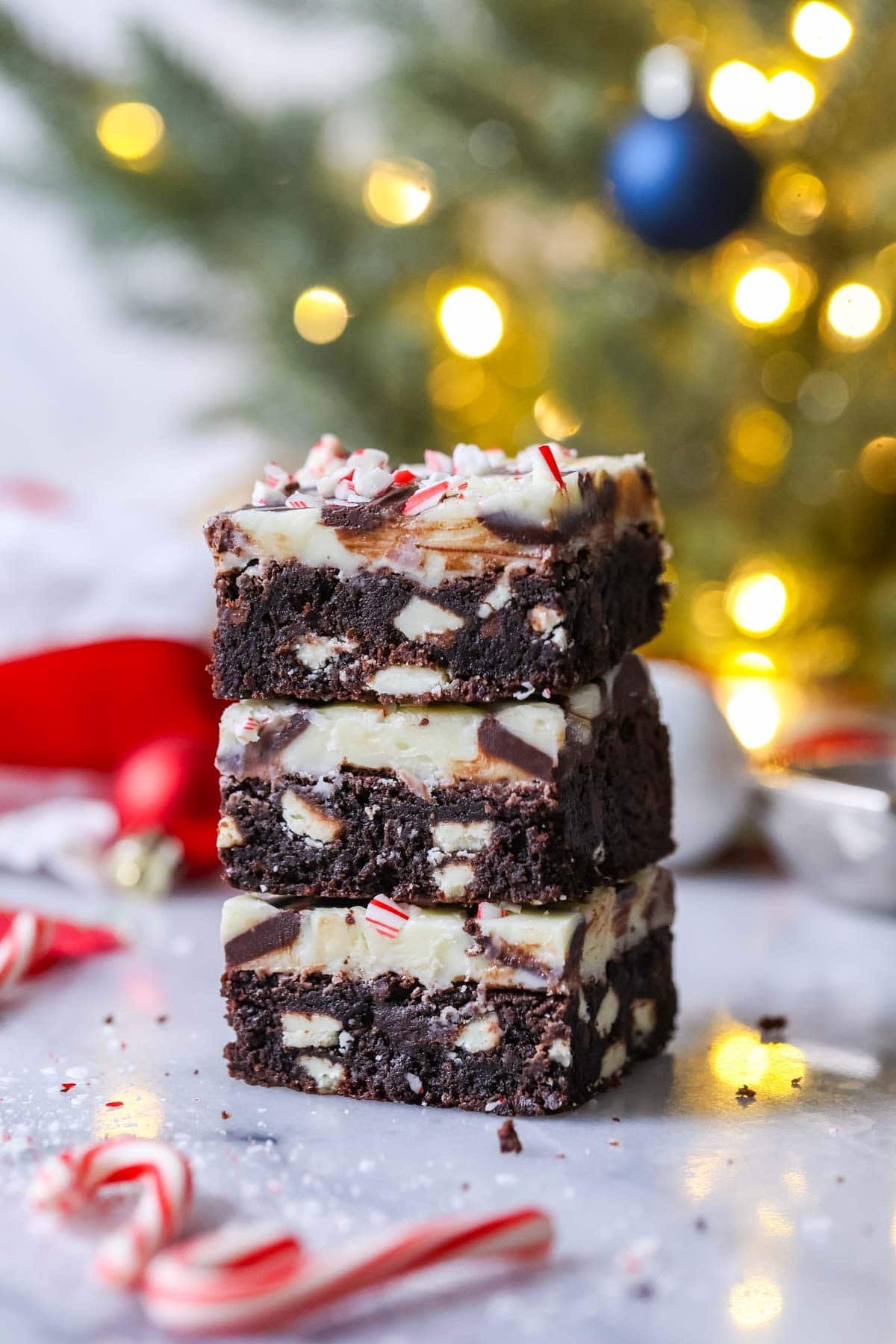 Stack of three peppermint bark brownies.