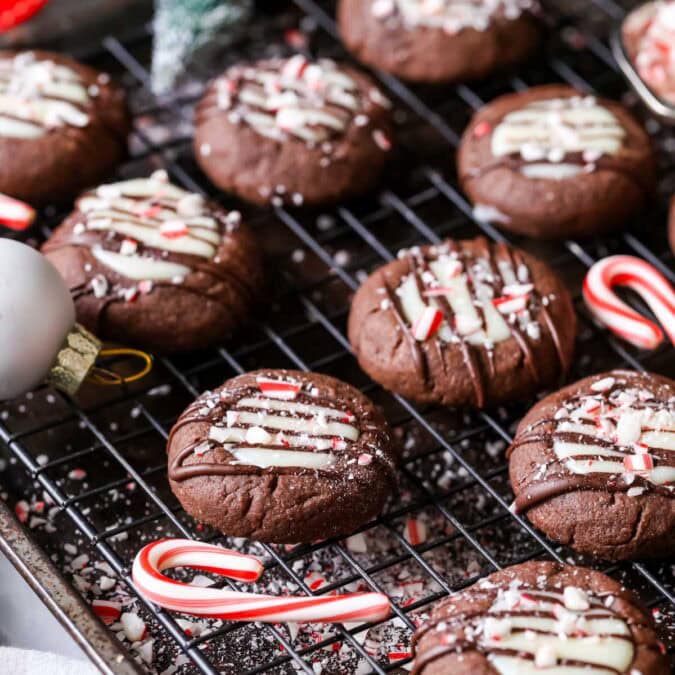 Close-up of chocolate peppermint thumbprint cookies on a cooling rack.