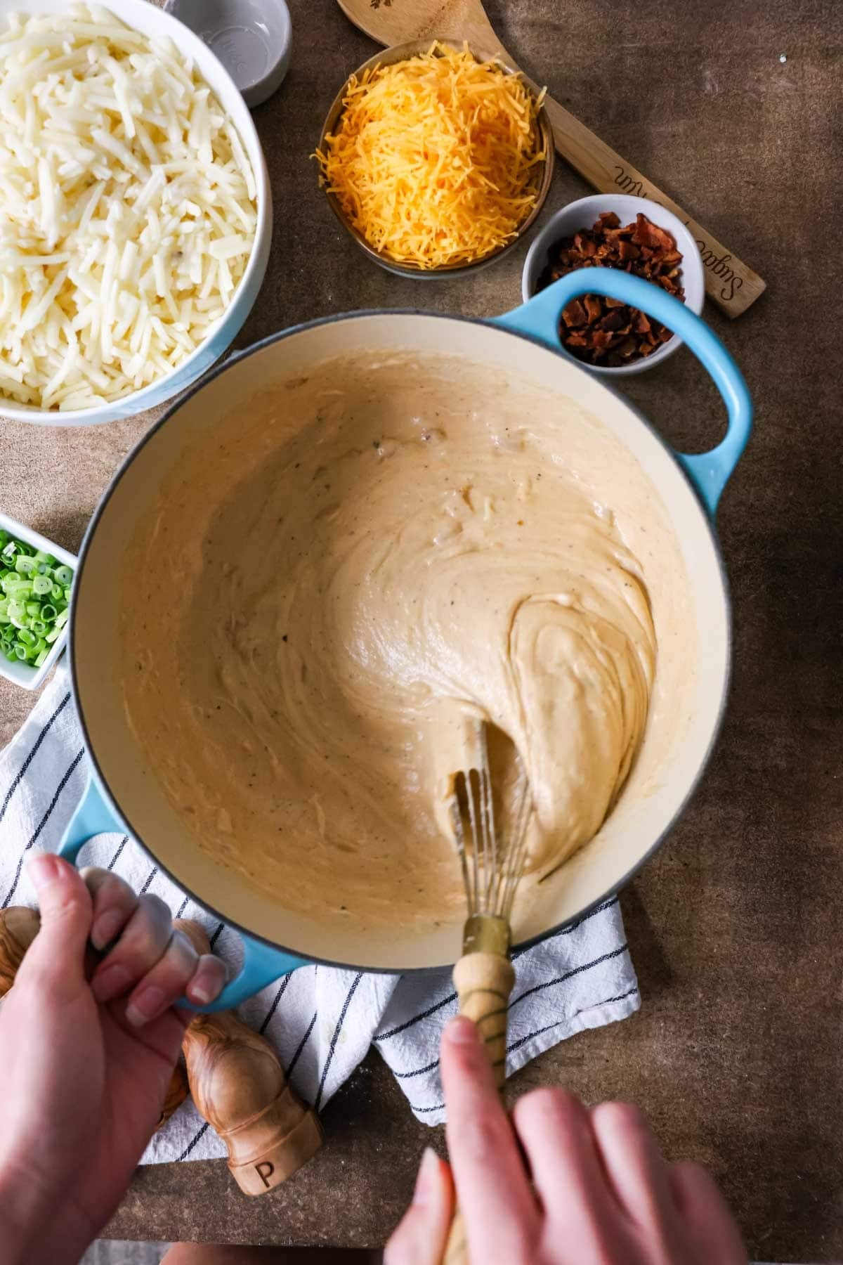 Overhead view of thickened cheese sauce in a pot.
