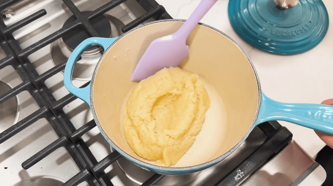 Choux dough in a pot before adding the eggs.