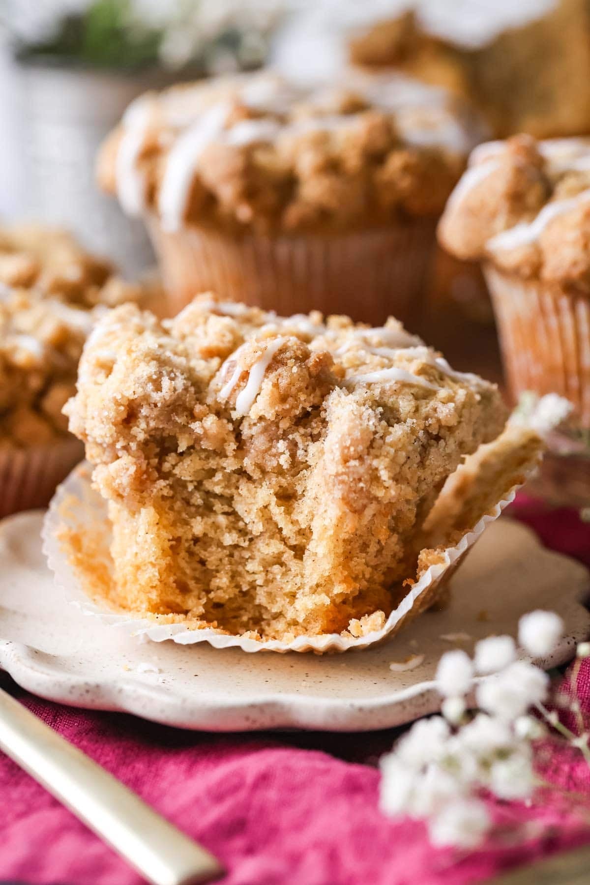 Bite missing from a streusel topped coffee cake muffin.