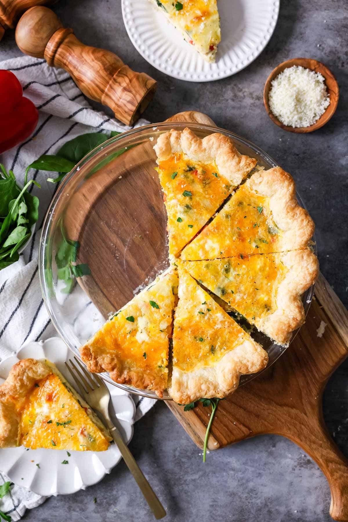 Overhead view of slices of quiche in a pie plate.