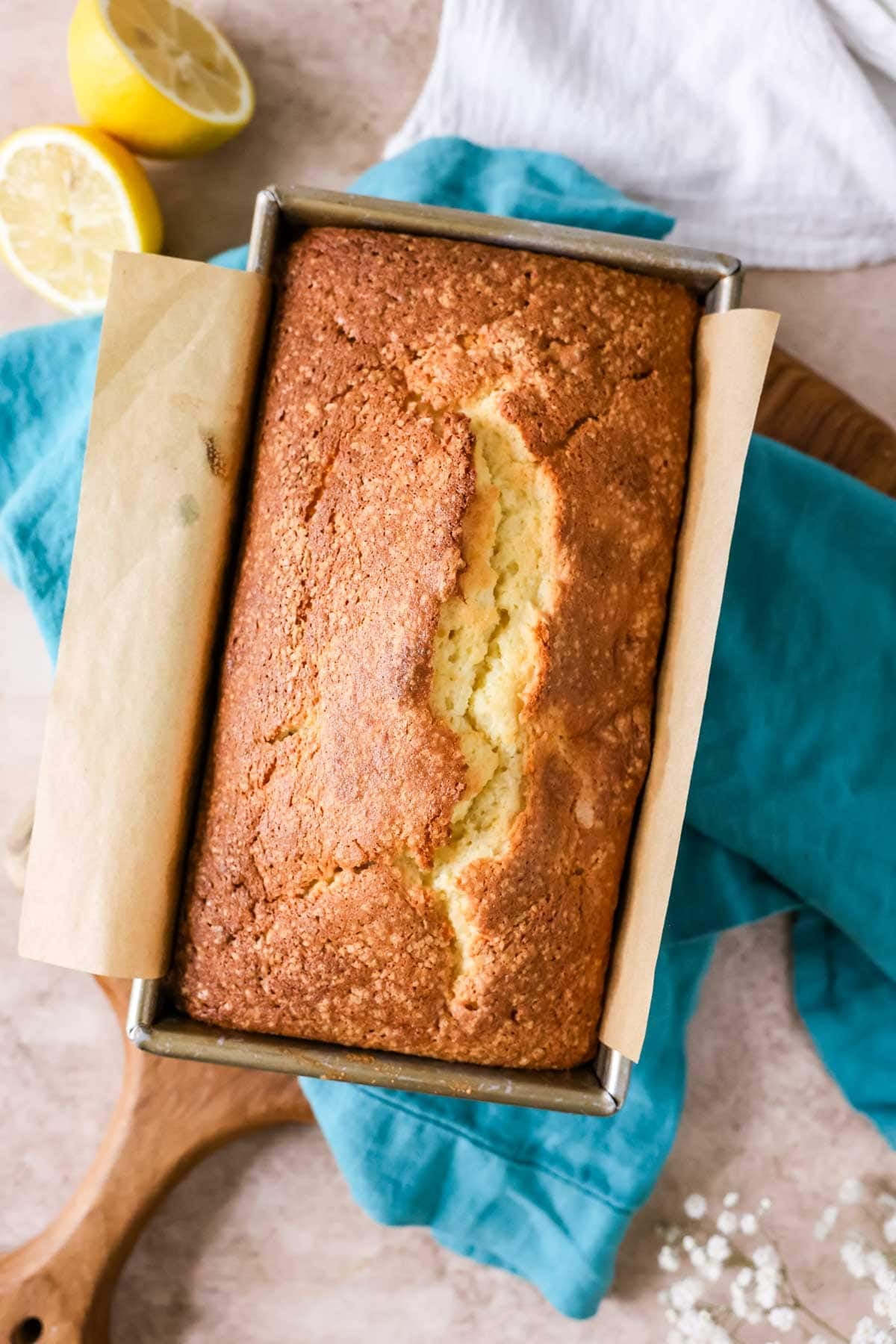 Overhead view of a lemon loaf in a pan after baking.