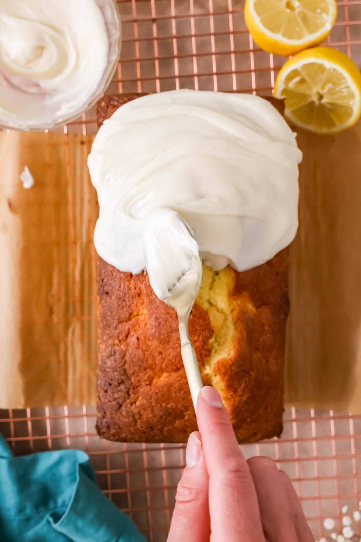 Smoothing lemon glaze over a loaf after baking.