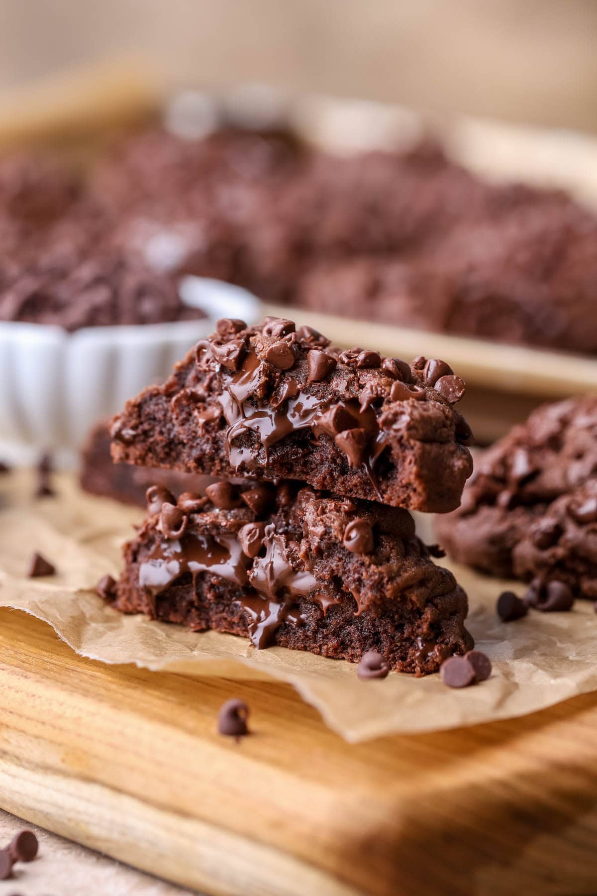 Two halves of a thick double chocolate cookie stacked on top of each other.