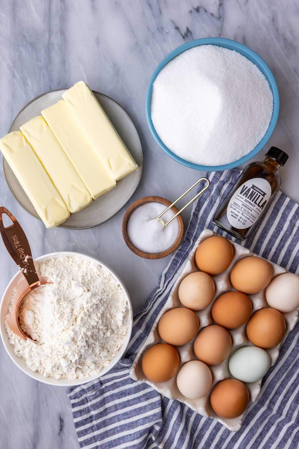 Ingredients for my pound cake recipe on marble backdrop.