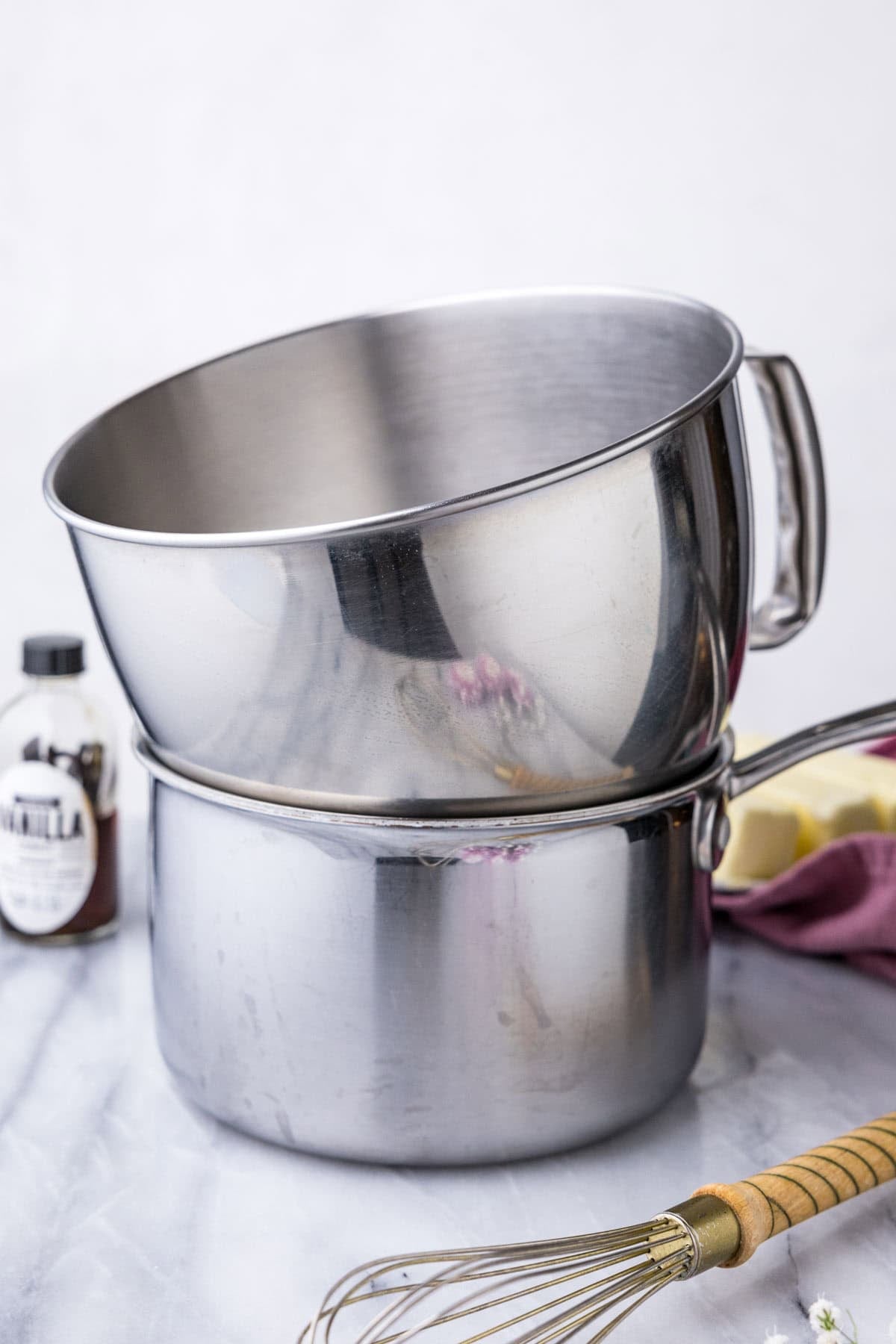 Double boiler setup with a stand mixer bowl inside of a saucepan.